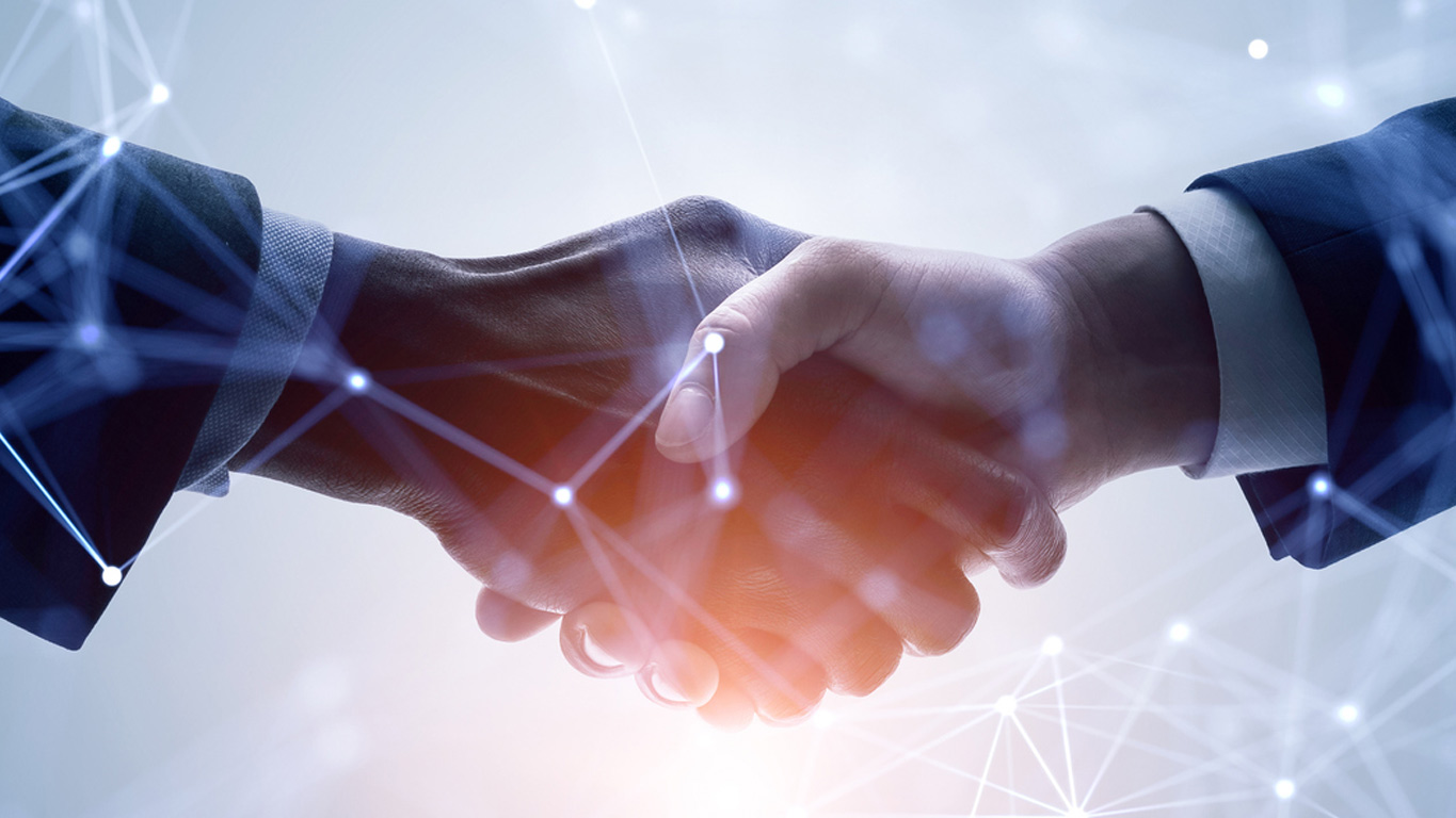 Two people shaking hands representing deals made
